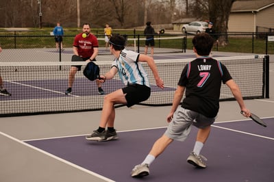 students and teachers playing pickleball